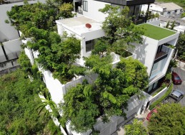Zieleń zintegrowana z bryłą budynku mieszkalnego – oto sposób na przywrócenie roślinności do miast. Pudełkowa architektura domu w Bangkoku doskonale komponuje się z zaprojektowaną roślinnością. 
